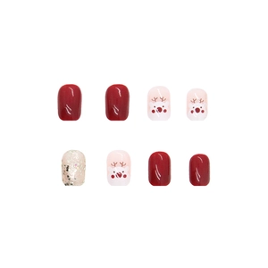 Christmas press-on nails featuring garnet red glossy finish and cute reindeer patterns