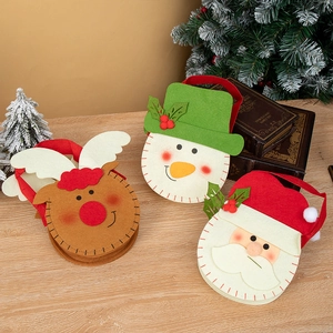 Christmas felt gift bags featuring Santa, Snowman, and Reindeer styles on wooden table