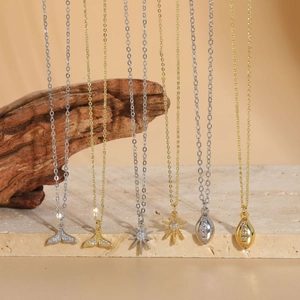 Detail of fishtail and sunburst pendants with zircon in 14K gold and silver plating