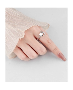 Close-up of a rotating star and moon ring in silver on a model's finger
