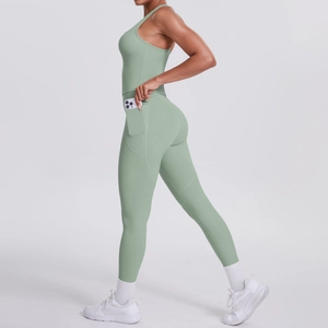 Close-up of yoga leggings with side pocket holding a smartphone in sage green fabric