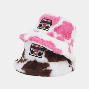 Winter plush bucket hat with retro cassette patch in pink and brown cow print pattern