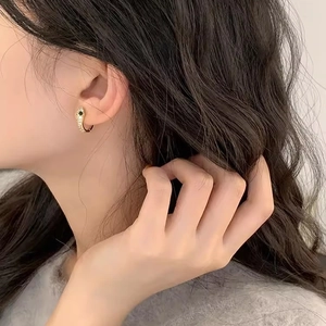 Chic S925 silver gold snake hoop earrings with zircon stones worn by a model