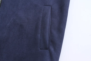 Detail of navy blue suede jacket showing smooth pocket stitching and premium fabric texture