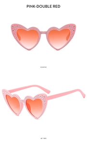 Pink heart-shaped rhinestone sunglasses with orange gradient lenses and star accents