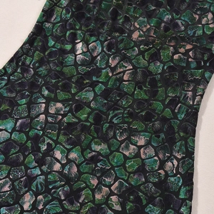 Detailed macro view of dark green and black marble print on velvet texture fabric