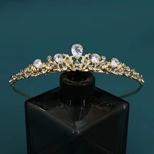 Detailed view of luxury bridal tiara with gold base and sparkling white zircon crystals