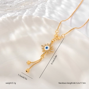 Macro shot of gold sun evil eye necklace with zircon stones and dimension markings