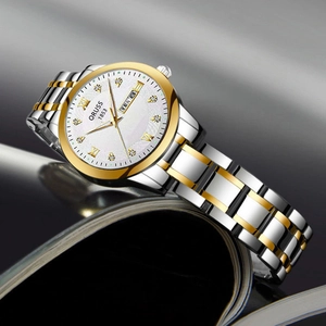 Minimalist silver and gold two-tone women's watch with small white dial and rhinestones