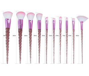 Macro view of crystal unicorn spiral handles with red glitter and pink gradient bristles