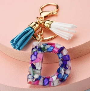 Colorful resin letter D keychain with glitter stones and blue-white tassels charm