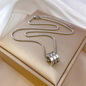 Polished silver titanium steel cylinder pendant on a sleek box chain for women