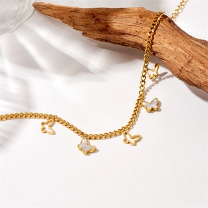 Detailed view of gold stainless steel anklet with butterfly and mother of pearl charms