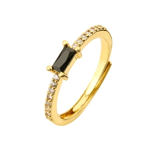 Macro view of gold ring featuring a rectangular black stone and white zircon stones