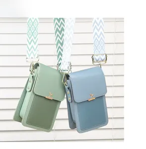 Detail of green and blue mini shoulder bags with lychee pattern and wide woven strap