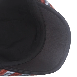Detail of tweed checkered newsboy cap with synthetic leather brim and stitching