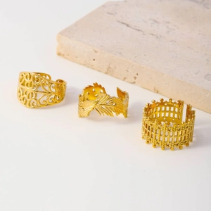 Three gold stainless steel adjustable open rings with feather and mesh textures