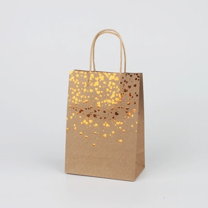 Brown kraft paper gift bag with metallic gold heart pattern and twisted paper handles