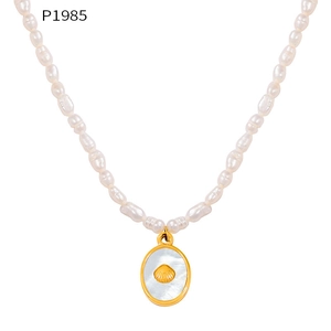 Detail of freshwater pearl necklace featuring a shell pendant with white mother of pearl inlay