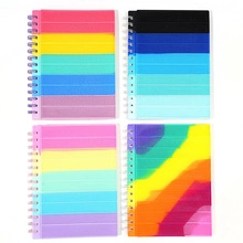 Detail of colorful spiral notebooks with transparent covers in 2x2 grid layout