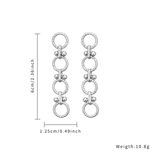 Detail view of geometric drop earrings with dimensions and textured silver-tone rings