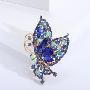 Macro view of butterfly brooch with dark blue rhinestones and iridescent crystals
