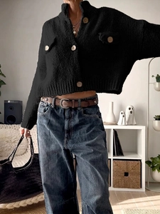 Women's black chunky knit cardigan sweater with vintage wooden buttons and ribbed cuffs