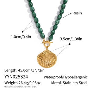 Detail of dark green resin bead necklace with gold shell pendant and OT clasp