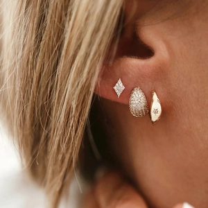 Detail of 18K gold plated silver earrings with pavé zircons and star motif design
