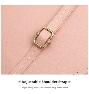 Detail of adjustable shoulder strap with golden metal buckle and white stitching on pink leather