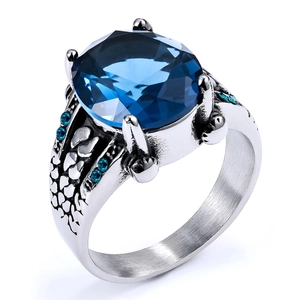 Detail of vintage steel ring with blue gemstone, six-prong setting and scale textures