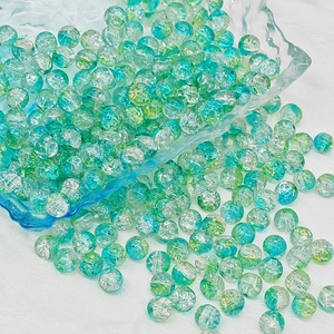 Detailed view of 8mm teal cracked glass beads for DIY jewelry and handmade crafts