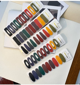 Detail of multi-color matte metal hair clips set in Morandi tones on a card display