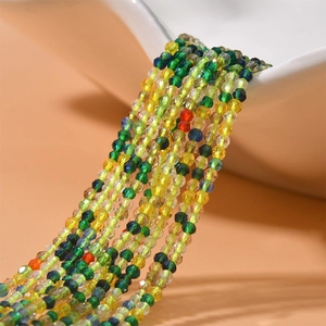 Strand of 2mm faceted colorful crystal beads spilling from a ceramic bowl for DIY jewelry