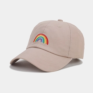 Close-up of vibrant rainbow embroidery on a beige cotton canvas baseball cap