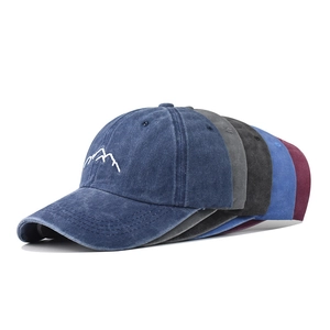 Detailed embroidery of mountain peaks on washed cotton vintage baseball caps in five colors