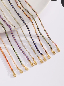 Detail of natural stone beaded necklaces with gold spacers and lobster clasp