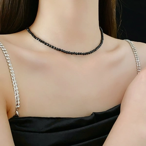 Close-up of a black beaded choker necklace on a female model neck for a minimalist style