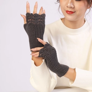 Detail of dark grey cable knit fingerless gloves with elegant hollow wave pattern