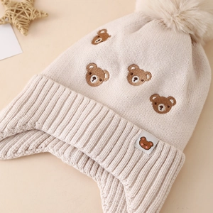Beige winter knitted hat for baby boys with bear embroidery and faux fur pom-poms