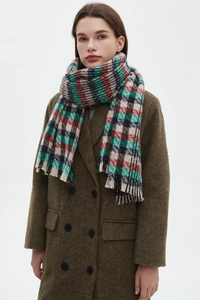 Detail of plaid scarf texture with red and green checkered patterns and short fringes