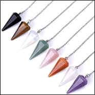 Detailed view of eight assorted conical gemstone pendants in various colors with metal chains