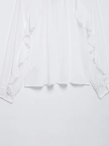 Detail of elegant white chiffon blouse featuring ruffled sleeves and buttoned cuffs