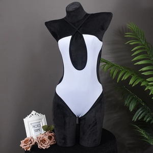 Detail of cross halter neckline with oval cutout on black and white one-piece swimsuit