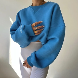 Detail of blue crewneck sweatshirt with white INSTUNNIN text print on the sleeve cuff