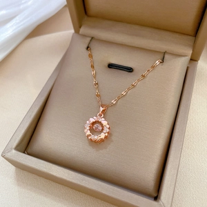 Elegant rose gold circular pendant necklace with sparkling zircons in a jewelry box