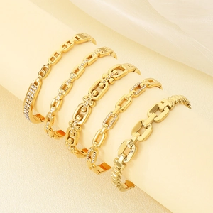 Luxurious gold stainless steel chain bracelets set with crystals on display stand