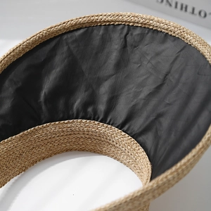 Detail of the woven straw exterior and black comfort inner lining of the sun visor hat