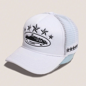 Close-up of white trucker hat showing black star embroidery and breathable mesh back
