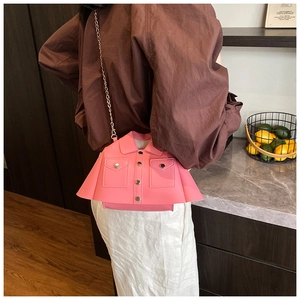 Close-up of pink PU leather jacket-style crossbody bag with silver chain strap